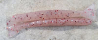 Soft plastic lure glows in the dark, pink and white, with glitter. Fishing lure that is two tone.